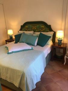 a bedroom with a large bed with two lamps at LUXURY House in VILLA POMPEIANA Via Camerelle con Terrazza Vista Mare in Capri