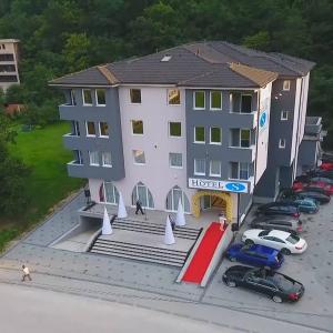 an aerial view of a hotel with a parking lot at Hotel S SAN in Novi Pazar