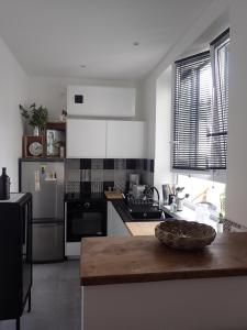 Cuisine ou kitchenette dans l'établissement Appartement tempéré avec terrasse