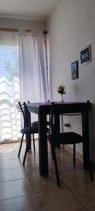 a dining room table and chairs with a vase on it at Las Colinas in Salta