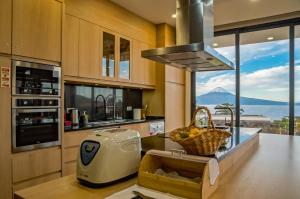 a kitchen with a view of a mountain at Make it Happen Farm in Urzelina