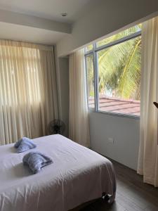 a bedroom with a bed and a large window at D ARC Leisure Home By The Sea in Panglao