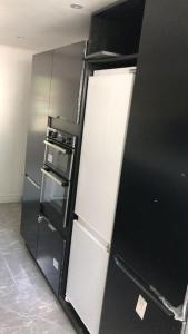 a black and white refrigerator in a kitchen at Holiday home in DʼArbeau