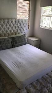 a bedroom with a large bed with a headboard and a window at Holiday home in DʼArbeau