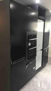 a black refrigerator with an open door in a kitchen at Holiday home in DʼArbeau