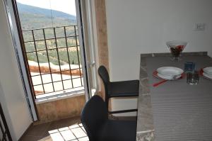a dining table with a view of a balcony at Casa Trevi via Fantosati in Trevi +29 photos
