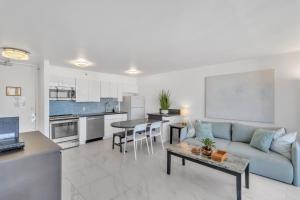 a living room and kitchen with a couch and a table at Standard Ocean View Condo - 36th Floor, Free parking & Wifi condo in Honolulu