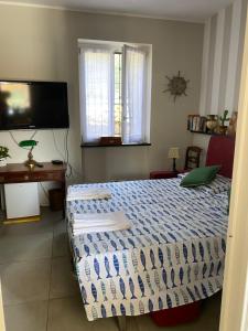 a bedroom with a bed and a television at Le Magnolie in Santa Margherita Ligure +13 photos