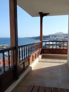a balcony of a building with a view of the ocean at Apartamento Neptuno in Candelaria