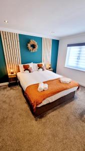 a bedroom with a large bed with towels on it at Bed& Boujee by the pier in Paignton