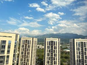 a view of three tall buildings in a city at Жк «Комфорт сити» in Almaty