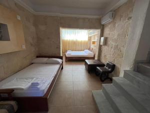 a small room with two beds and a window at HOUSE ALLA in Pefkohori