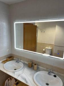 a bathroom with two sinks and a large mirror at Rincón Costero in Rincón de la Victoria