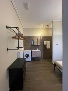 a bathroom with a washer and dryer in a room at City apartment in Korinthos