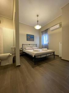 a bedroom with a bed and a bathroom with a sink at City apartment in Korinthos