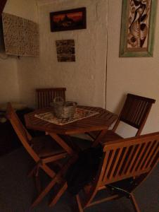a dining room table with two chairs and a table with a basket at La Juana in Carmelo