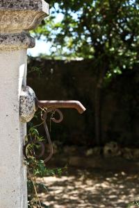 a pair of scissors attached to a stone wall at NEW! Gîtes de Charme au Mas de Soleil in Goudargues