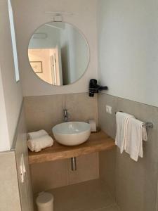 a bathroom with a sink and a mirror at La Casa sul Lago Apartments - Olive Tree Apartment in Limone sul Garda