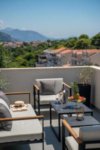 a patio with a table and chairs on a balcony at Luxury Suite All You Need in Dubrovnik