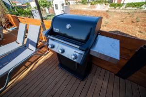 a grill sitting on top of a deck at Boutique hotel with a heat pool in Dosemealti