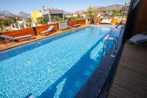 a large swimming pool with two chairs next to it at Boutique hotel with a heat pool in Dosemealti