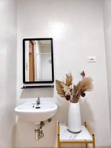 a bathroom with a sink and a mirror at Condo in Quezon City, Trees Residences Tower 16 in Manila