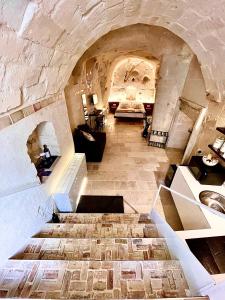 a large room with a stone floor with a sink at CASA VACANZE BB 164-166 in Matera