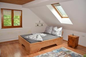 a bedroom with a bed and a skylight at Happy Point Apartment in Mellau