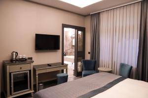 Postel nebo postele na pokoji v ubytování ARCHSTONE BY KETENCİ HOTEL