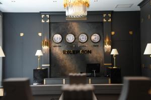 a waiting room with clocks on the wall at ARCHSTONE BY KETENCİ HOTEL in Konak