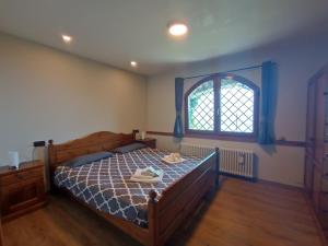 1 dormitorio con cama y ventana en Villa VaLuRi vista magnifica sul Lago di Como Appartamento piano terra, en Vercana