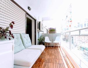 sala de estar con sofá y sillas en el balcón en Elli’s Home, en Tesalónica
