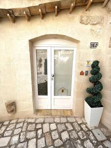 a door to a building with a plant next to it at CASA VACANZE BB 164-166 in Matera