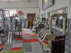 a gym with rows of treadmills and machines at Devereux Lodge in East London