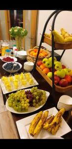 a table topped with plates of fruit and drinks at Belrom Hotel in Sint-Truiden