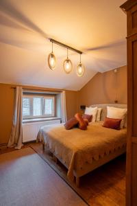 a bedroom with a large bed with lights on it at Le Nid de la Canette in Durbuy