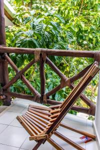 a rattan chair sitting on top of a porch at Bed & Breakfast Casaejido in Playa del Carmen