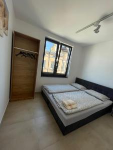 a bedroom with a bed and a wooden door at Apartament III w Centrum - Winda - 50 metrów od Starego Rynku in Kościerzyna