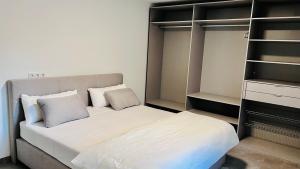 a bedroom with a bed and a book shelf at City Apartments in Herzogenaurach