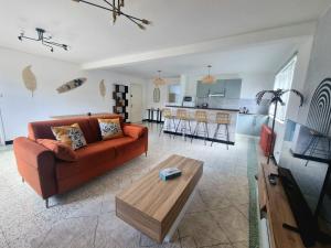 a living room with a couch and a table at L'Arena - Le Terrazzo in Liévin