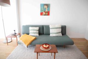 a living room with a green couch and a table at Sommerfrische Uckermark in Warnitz