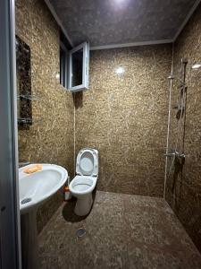 a bathroom with a toilet and a sink at Guest House Violeta in Gonio +20 photos