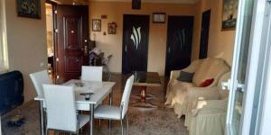 a living room with a table and chairs and a couch at Guest House Violeta in Gonio