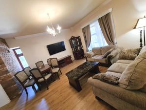 a living room with a couch and a table at Villa Rusalka in Vysoke Tatry - Tatranska Kotlina