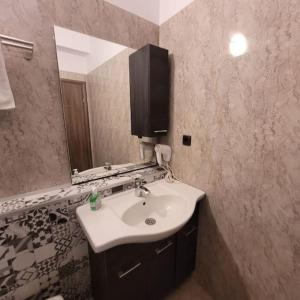 a bathroom with a sink and a mirror at Anastasia 1 Balcescu apartment in Bucharest