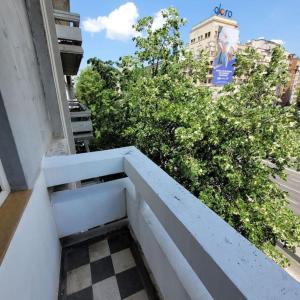 a balcony with a checkered floor on a building at Anastasia 1 Balcescu apartment in Bucharest