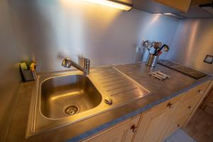 a stainless steel sink in a kitchen with a counter at Le Surf 1 in Mussillon