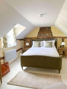 ein Schlafzimmer mit einem großen Bett im Dachgeschoss in der Unterkunft The Pear Tree Inn in Bury Saint Edmunds