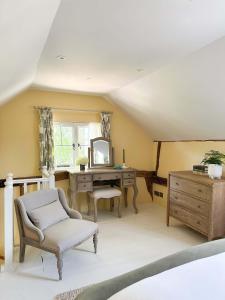an attic room with a desk and a mirror at The Pear Tree Inn in Bury Saint Edmunds