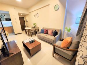 uma sala de estar com um sofá e uma mesa em Modern One Bedroom Condo at Mactan, Cebu em Mactan